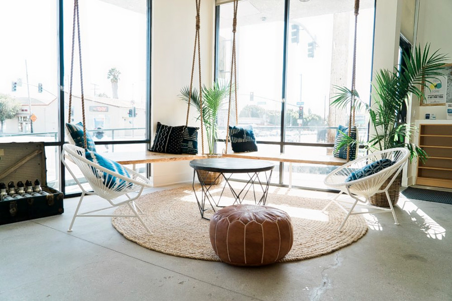 Waiting area with comfortable looking chairs and a fuzzy carpet at Modo Yoga