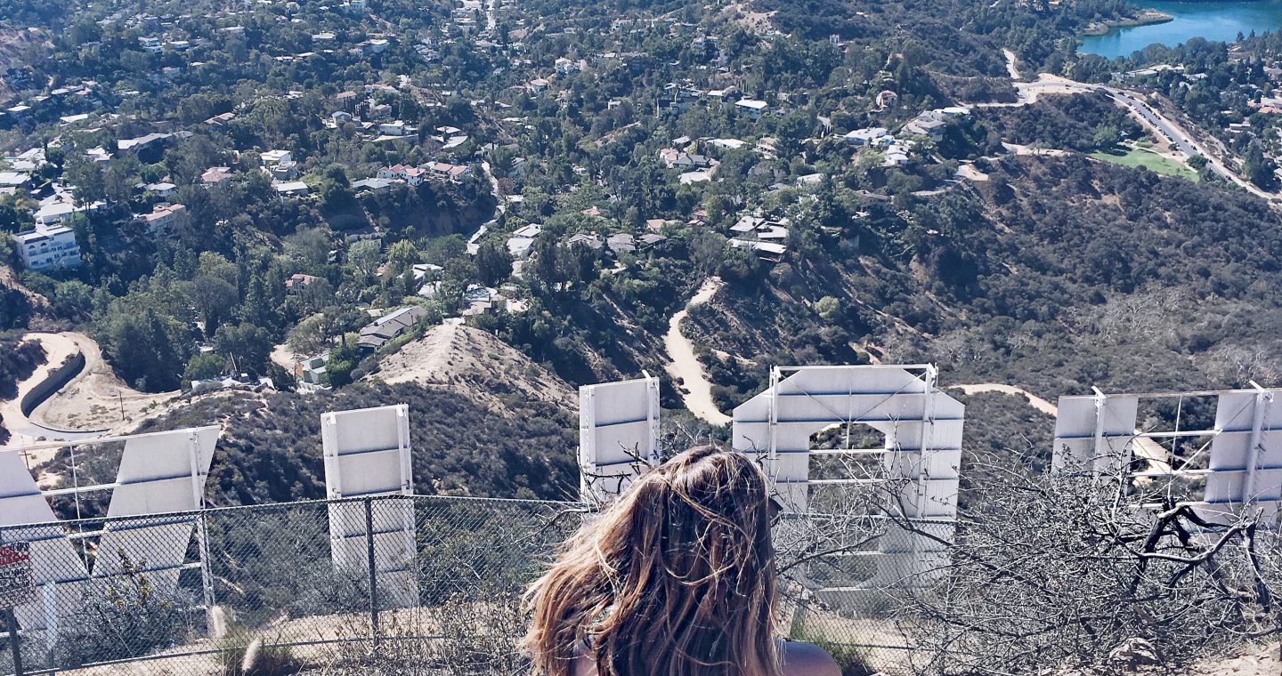 Erin sitting behind the Los Angeles Hollywood sign