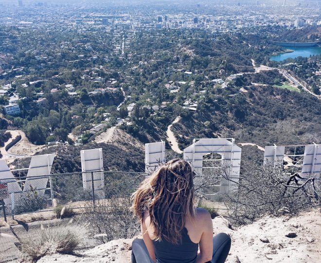 Erin sitting behind the Los Angeles Hollywood sign