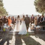 Erin walking up the aisle with her mom and dad on her arm.