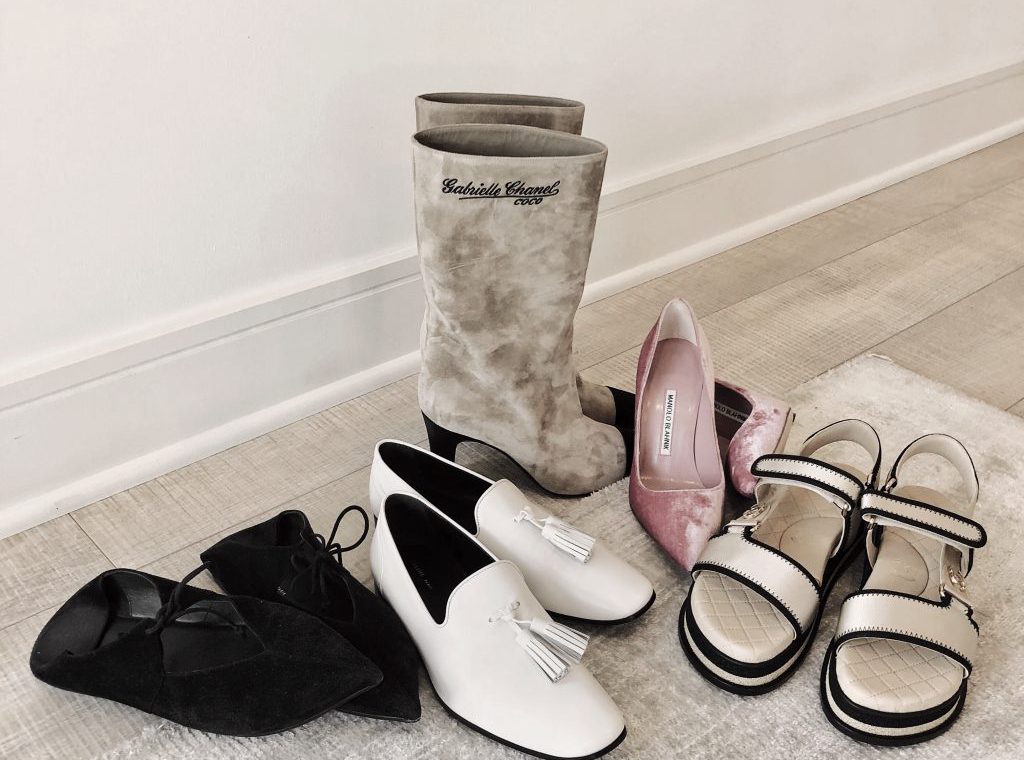 5 pairs of designer shoes arranged on the floor.