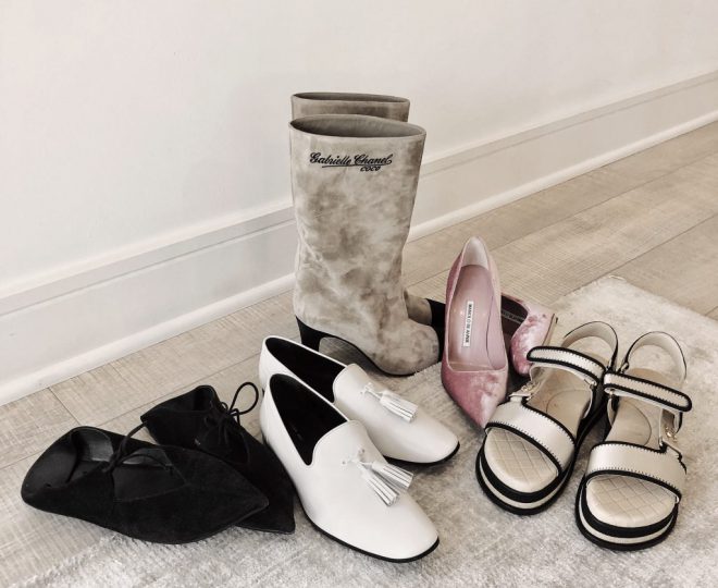 5 pairs of designer shoes arranged on the floor.