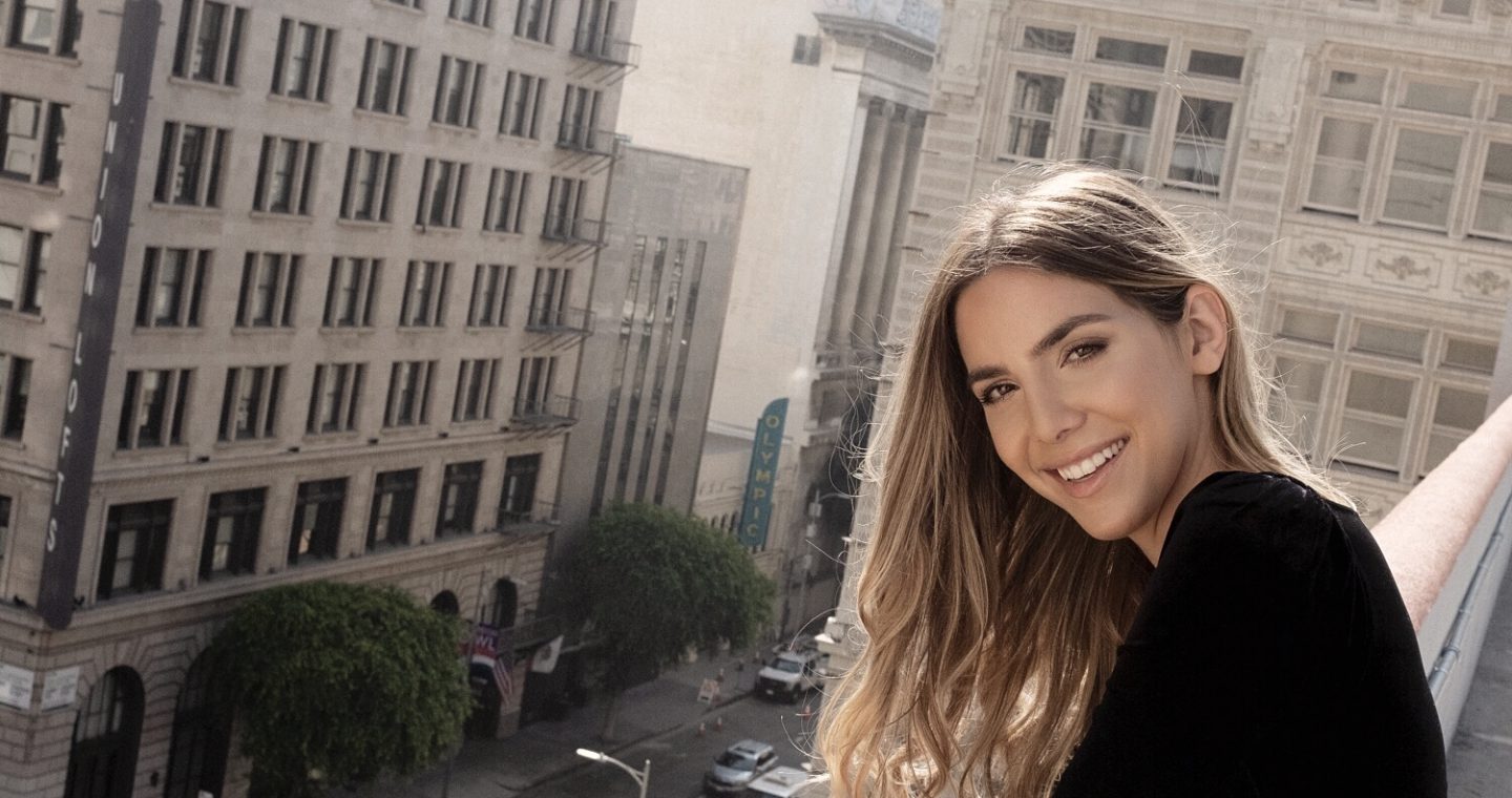 Erin standing on a rooftop smiling