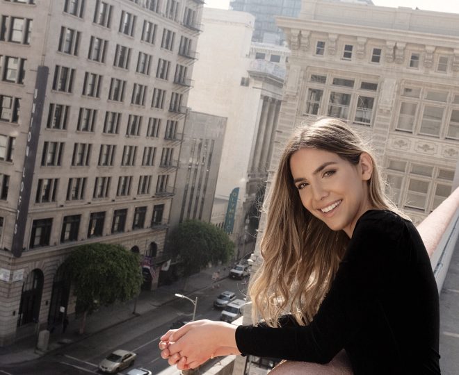 Erin standing on a rooftop smiling