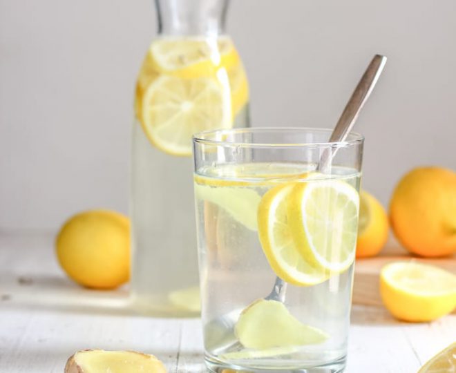 glass of water with lemon slices in it
