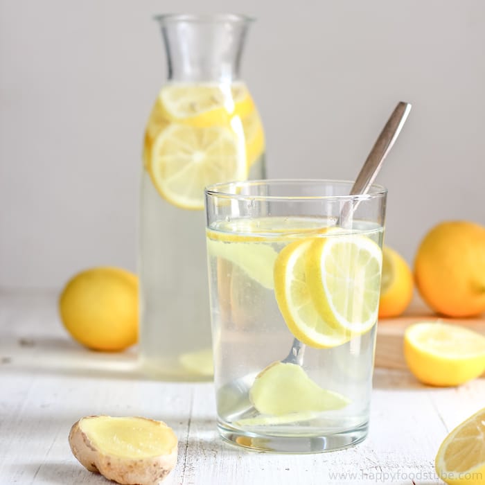 glass of water with lemon slices in it